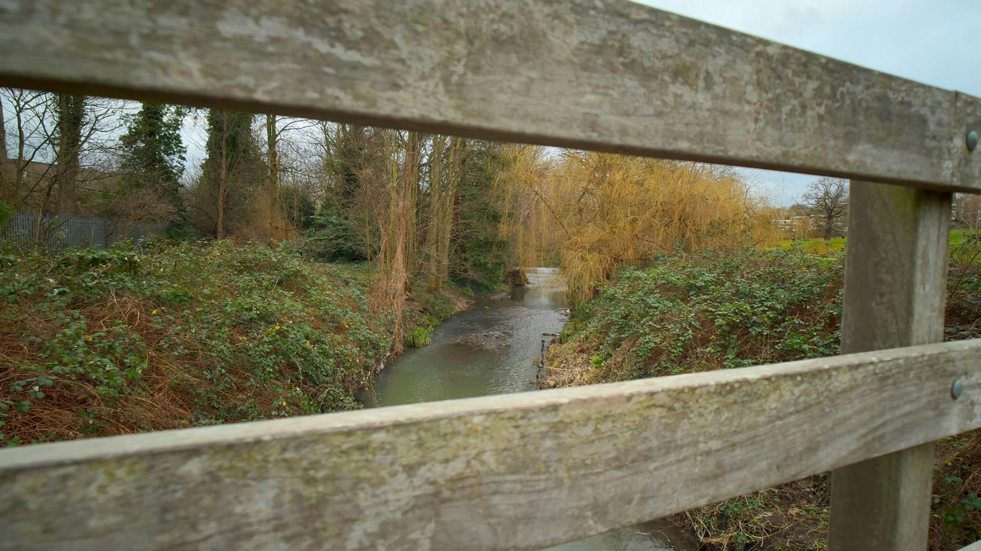 A river through bridge posts.